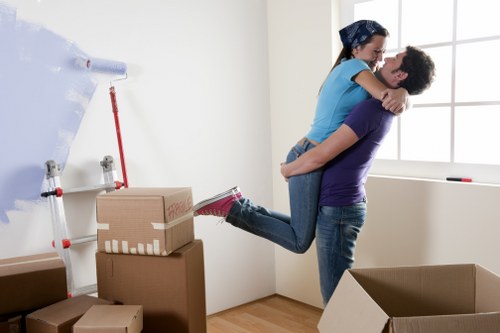 Movers carrying boxes from a Fitzrovia flat