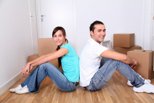 Driver helping load furniture into a van for a Fitzrovia move