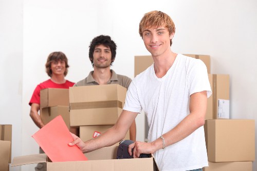 Professional movers carrying household items through a Fitzrovia apartment building